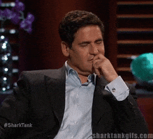 Reality TV gif. Mark Cuban on Shark Tank winces in second hand embarrassment and face palms into his hand.