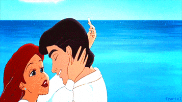 Disney gif. Ariel grasps Eric as she kisses him passionately in the Little Mermaid.