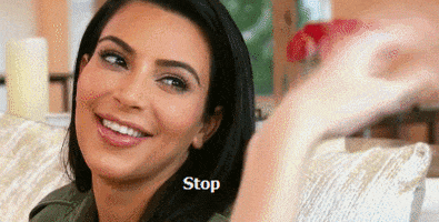 Celebrity gif. Kim Kardashian playfully looking at someone and saying "stop."
