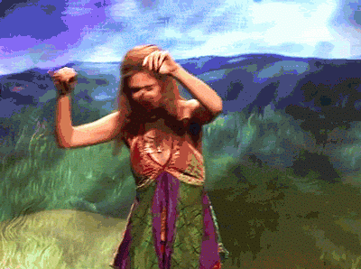 Gif of Kirsten Wiig dressed like a hippy dancing