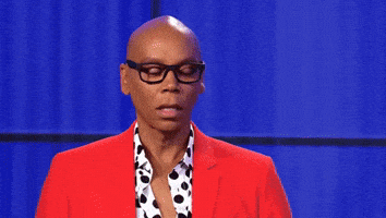 Celebrity gif. RuPaul looks off screen and speaks with glowing words that come on screen. Text, "This is next level gay shit."