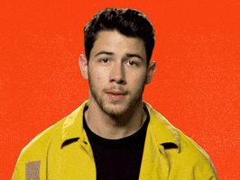 Celebrity gif. Nick Jonas looks at us in disbelief and rolls his finger in a circle near his temple as if to insinuate "crazy." As he does this, a zigzagging yellow circle appears around him, emphasizing the crazy.