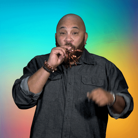 Video gif. A man gives a thumbs up and blows a party horn. Text, "happy new year!"