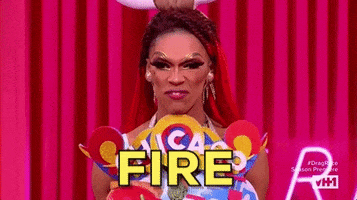 Reality TV gif. A Drag Queen on Rupaul's Drag Race wears a chicago themed costume. She looks at us fiercely as she says, “Fire.” 
