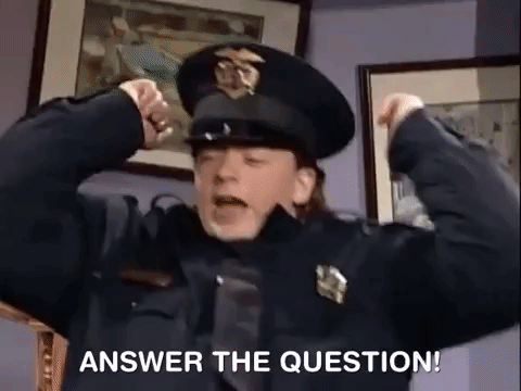 a police officer is flexing his muscles and saying answer the question .