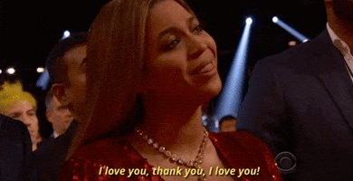 Celebrity gif. Beyonce at the Grammys is seated in the audience and looks wistfully towards the stage, tears in her eyes, as she shakes her head slowly and says, "I love you. Thank you. I love you!"
