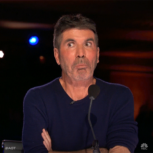 gif shows Simon Cowell on American Idol