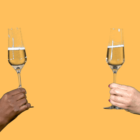 Video gif. Two glasses of sparkling wine clink in the center of a yellow background.