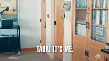 TV gif. Paula Pell as Helen in AP Bio strides eagerly into a classroom with a smile on her face. Text, "Tada! It's me."