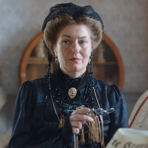 TV gif. Anna Chancellor as Julia in A Stranger in the Family dressed in 1800s-style clothes looks around, expressionless, and says loftily, "Do I know these people?" which appears as text.