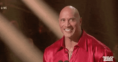 Celebrity gif. Dwayne The Rock Johnson at the 2021 People's Choice Awards smiling  and looking sincere, saying "thank you."
