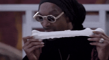 TV gif. Snoop Dogg from Snoop & Martha's Very Tasty Halloween. He's licking a bone made out of white chocolate and he licks it from end to end.