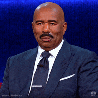 Reality TV gif. Steve Harvey on Little Big Shots smirks and then chuckles with a soft smile. 