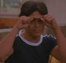 TV gif. Wilmer Valderrama as Fez on That 70s Show looks over at someone with earnest eyes and draws a heart in the hair with his fingers. He mouths silently, “I love you.”
