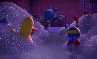Cartoon gif. Rubber ducks in Toy Story look at each other in the bathtub and they jump up and down in the water, screaming, "Awesome!"