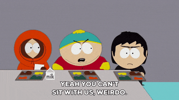 South Park gif. Kenny and Cartman sit with lunch trays at a cafeteria table looking at Damien who stands to the side. Cartman says, "Yeah you can't sit with us, weirdo," and then Damien replies, "Infidels! I will turn you all into beasts of burden!"
