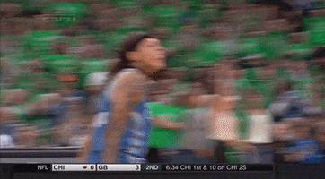 Sports gif. Seimone Augustus from the WNBA Minnesota Lynx is taunting someone on the court, sticking her tongue out and nodding her head.