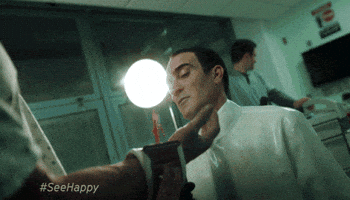 TV gif. In a clip from Happy, a doctor is splashed in the face by a stream of blood from a patient's wrist.