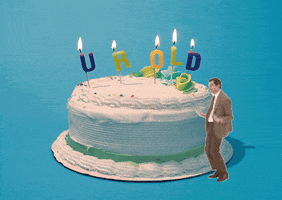 Video gif. Rowan Atkinson as Mr. Bean dances, thrusting his hips, in front of a large white birthday cake. On top of the birthday cake are candles that spell out “Your Old.”