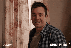 SNL gif. Jimmy Fallon smiles sheepishly and waves hello.