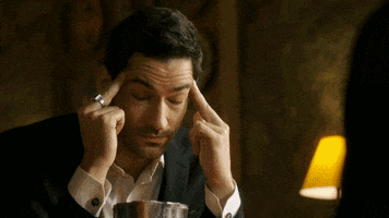 TV gif. Sitting at a table, Tom Ellis as Lucifer rubs his temples, then rolls his eyes, completely exasperated.