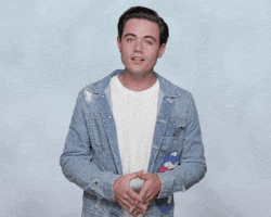 Celebrity gif. Wearing a denim jacket and a white shirt, Luke Cosgrove gives us an grimacing apology with hands clenched together. He turns up his hands and text appears, "Sorry."