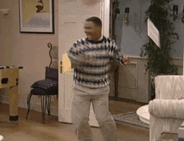 TV gif. Alfonso Ribeiro as Carlton on Fresh Prince of Bel Air dances happily. He spins around and excitedly jumps onto an end table and does a backflip into the air.