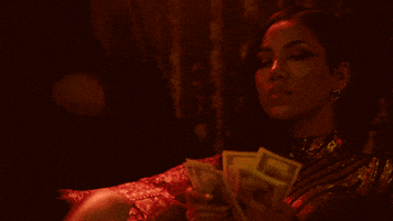 Music video gif. In a darkly-lit room, Jhene Aiko counts some money.