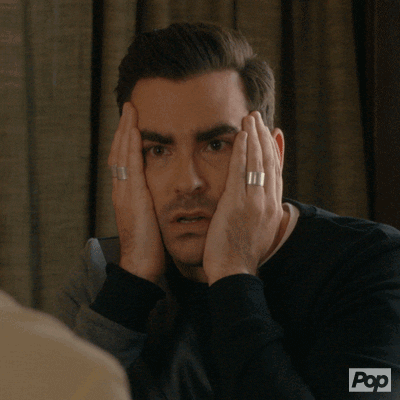 Schitt's Creek gif. Daniel Levy as David. He stares and listens intently, holding his face in his hands, clearly aghast at what he's hearing. He moves his face away from his hands to continue staring and listening in disbelief and slight disgust. 