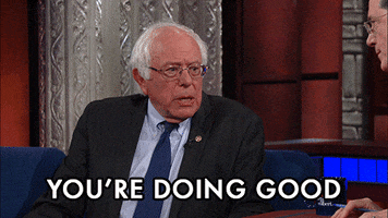Political gif. Bernie Sanders appears on The Late Show with Stephen Colbert. He uses his index finger to tap the host's notes and assure him that he's doing well. Text, "You're doing a good job."