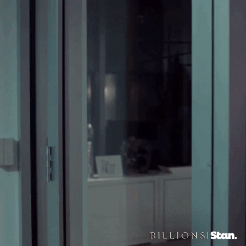 TV gif. David Costabile as Mike Wagner on Billions opens a glass door and leans out. He has a serious, angry expression on his face as he shouts, “Coffee!”