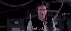 Star Wars gif. Harrison Ford as Han Solo gives us a little salute as he wishes us: Text, "Good luck."