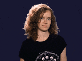 Video gif. Johanna Kenney gives an “Okay” hand sign and slyly winks at us twice.