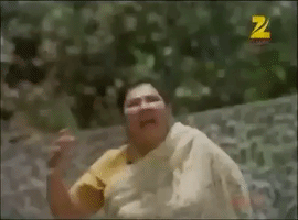 Video gif. An exhausted woman wearing a sari runs wearily, trying to catch her breath.