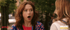 TV gif. Ellie Kemper as Kimmy in Unbreakable Kimmy Schmidt reacts to something in excited surprise, her mouth dropping open.