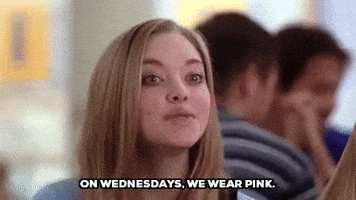 Movie gif. Amanda Seyfried as Karen in Mean Girls. She's sitting at a table and she happily says, "On Wednesdays, we wear pink."