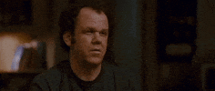 Movie gif. John C Reilly as Dale in Step Brothers shrugs, shakes his head and purses his lips as if to suggest he doesn't care.