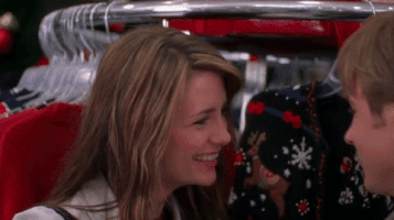 TV gif. Mischa Barton as Marissa in The OC smiles as she pulls Ben McKenzie as Ryan in for a kiss, running her fingers through his hair.