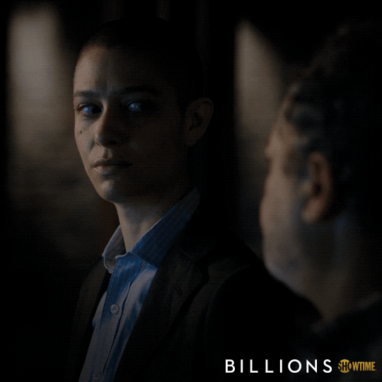 TV gif. Asia Kate Dillon as Taylor Mason on Billions looks over at David Costabile as Mike Wagner with white, nervous eyes and nods quickly as they say, “Right.”