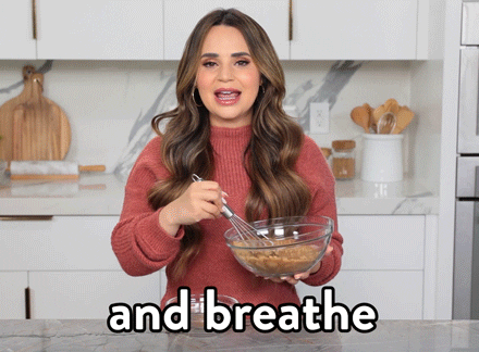 Gif of a woman stirring something in a bowl saying "and breathe" 