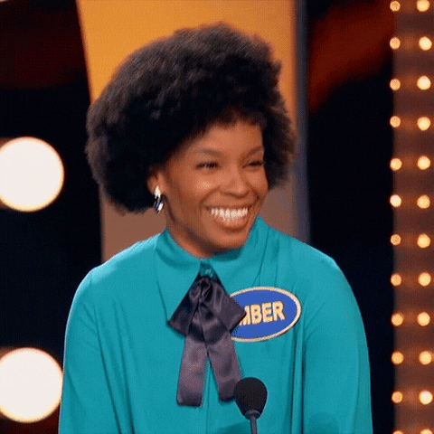 TV gif. Amber Ruffin, a comedian, is on Celebrity Family Feud. She throws her head back as she laughs and she grins winningly as she stands on stage.