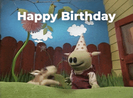 TV gif. Mona and her dog from Nanalan play on the grass in front of a house. Mona wears a party hat and the two of them hug and cuddle. Text, "Happy Birthday."