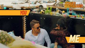 Movie gif. Salma Hayek as Sonia Kincaid and Ryan Reynolds as Michael Bryce in The Hitman’s Wife’s Bodyguard crouch behind a counter. Sonia slaps Michael with the back of her hand and his sunglasses fly off his face. 