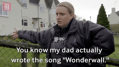 A Caucasian woman, leaning against a fence outside. The caption reads 'You know my dad actually wrote the song ''Wonderwall.''.