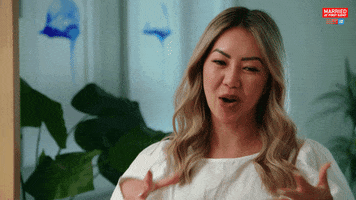 Reality TV gif. Being silly, Selina on Married at First Sight holds her hands up and sticks her tongue out, pretending to make out with someone, then smiles.