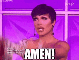 Reality TV gif. Raven in RuPaul's Drag Race wears a floral long sleeve one shoulder top, gazing upward and raising her arms above her. Text, "Amen!"