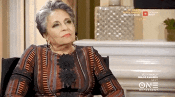 Celebrity gif. Cathy Hughes sits in a chair and nods with a smile on her face, agreeing to something wholeheartedly during an interview for the NAACP Image Awards 2019.