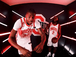Video gif. E.J. Liddell of the Ohio State Buckeyes basketball team moves close to camera as he rubs his fist against his eyes sarcastically like boo hoo for you. A person wearing a jersey and holding a basketball smiles in front of an Ohio State logo.