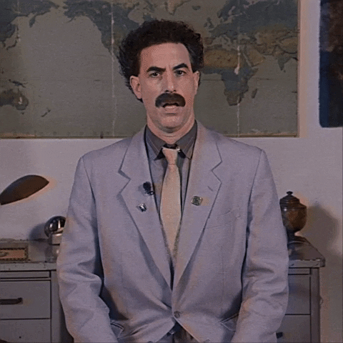 Movie gif. Sacha Baron Cohen as Borat faces us, sitting in front of a desk and world map, frowning while saying "I do not know," which appears as English text on top of Romanian subtitles.