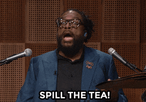TV gif. Questlove on the Tonight Show sits behind a drumkit and rhythmically, emphatically taps at the air with his drumsticks while speaking. Text, "Spill the tea!"